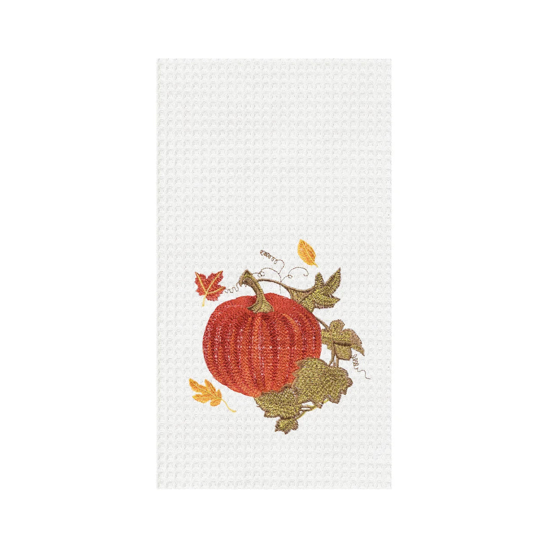 Decorative kitchen towel with a pumpkin and leaf design on a white background