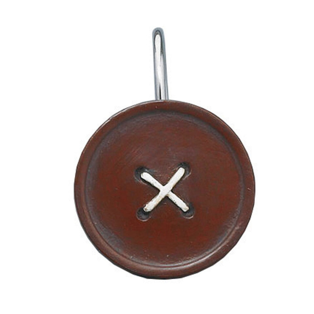 Brown button-shaped keychain with a metal ring on a white background