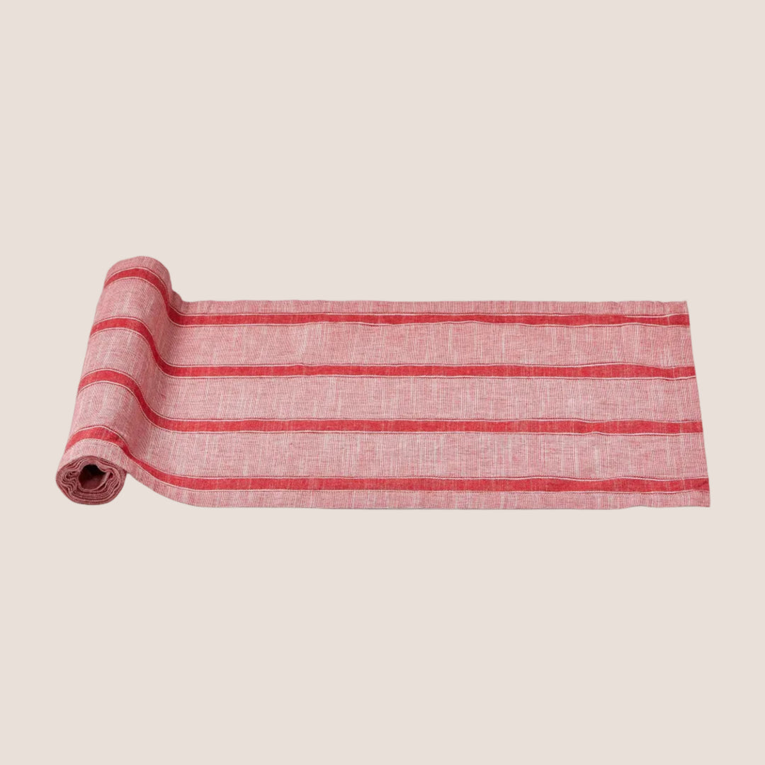 Rolled-up red and white striped fabric on a white background