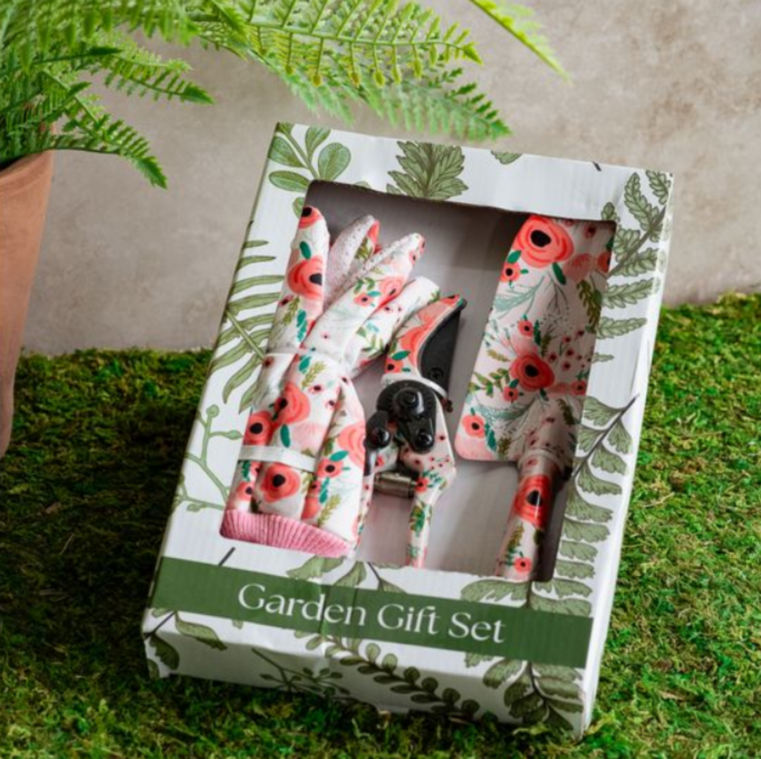 Floral gardening gloves and shears set in a decorative box on grass