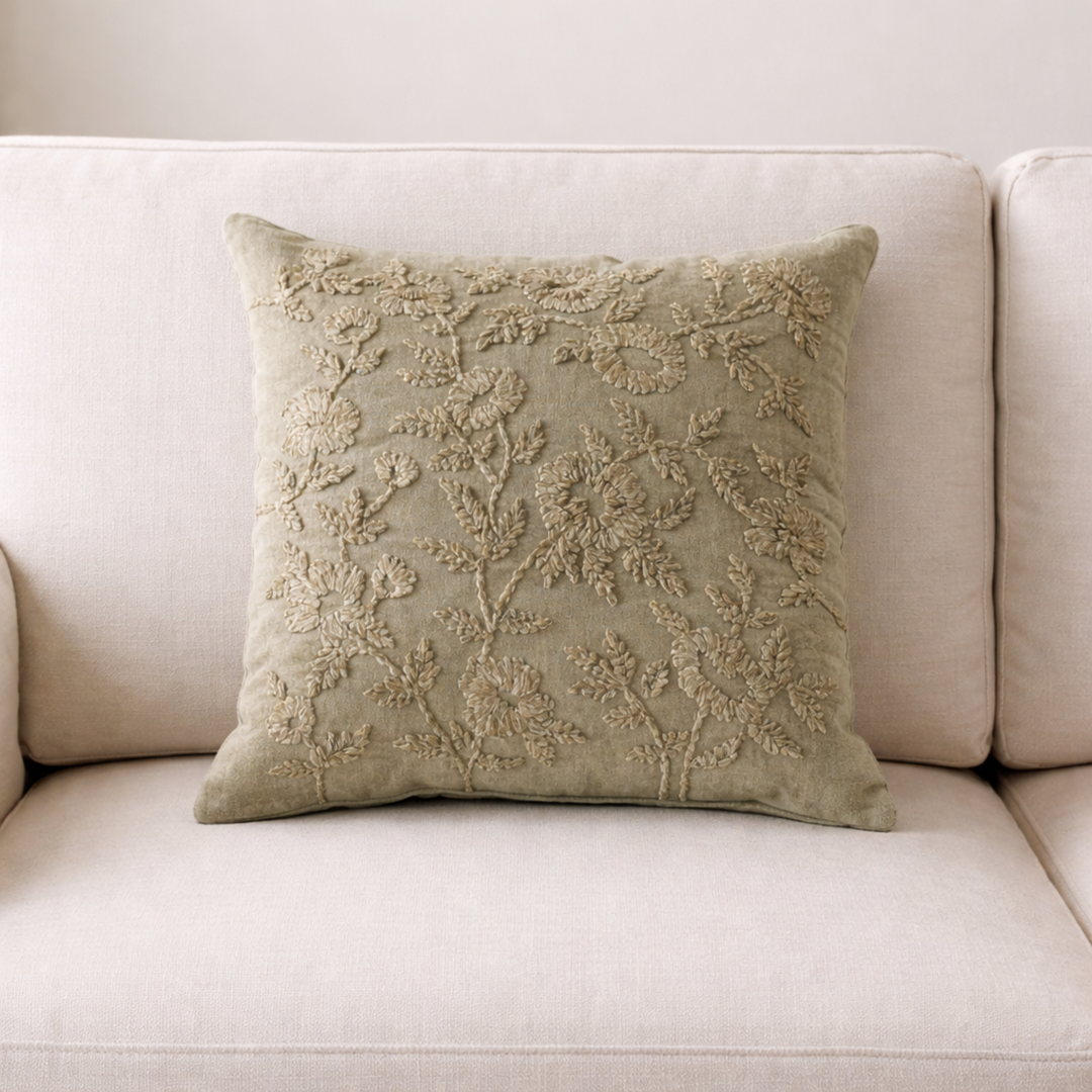 Decorative pillow with floral embroidery on a beige sofa