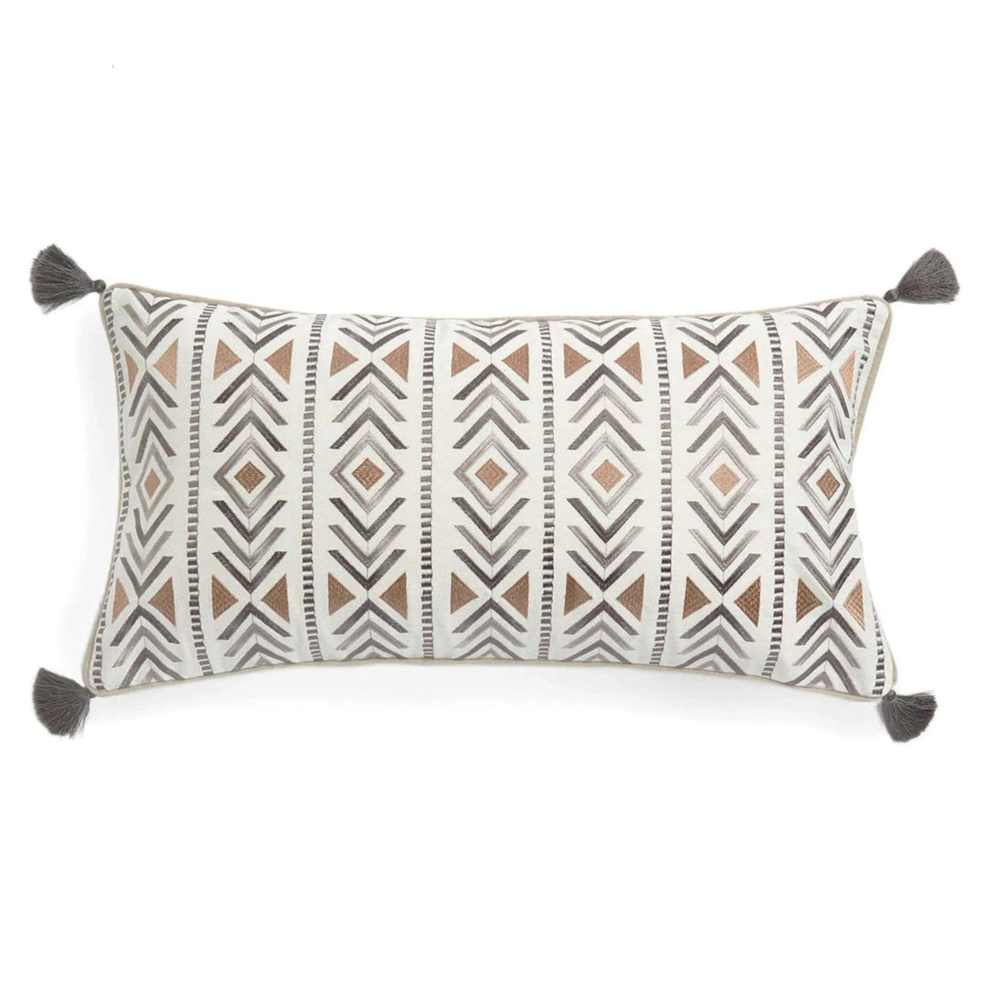 Decorative pillow with geometric pattern and tassels on a white background