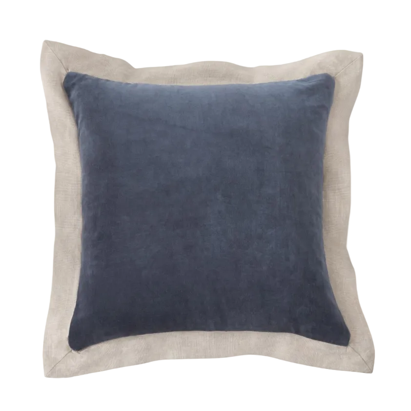 Blue pillow with beige border on a white background