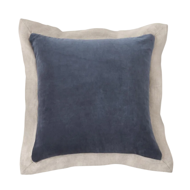 Blue pillow with beige border on a white background