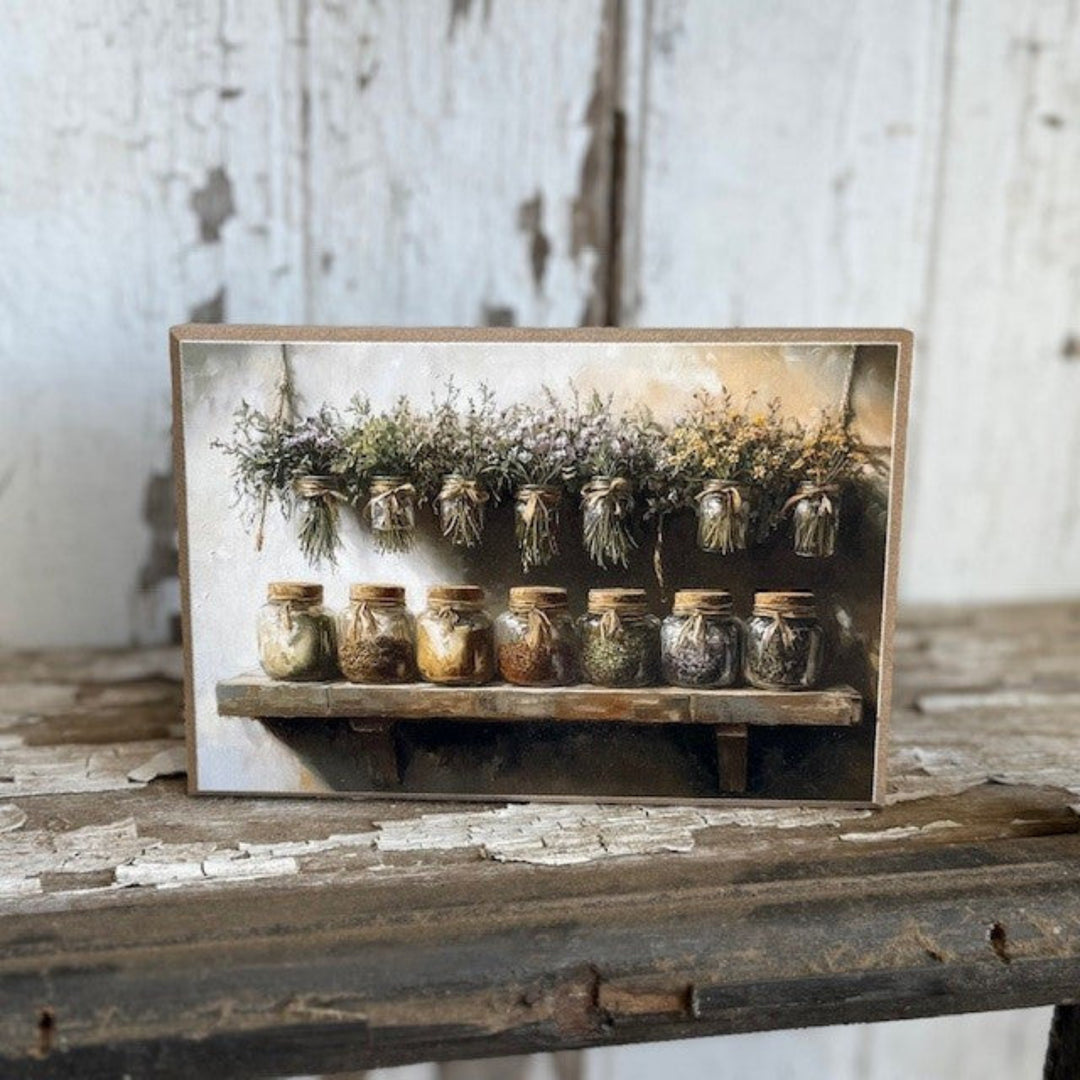 Decorative shelf with small jars and dried plants against a rustic wooden background