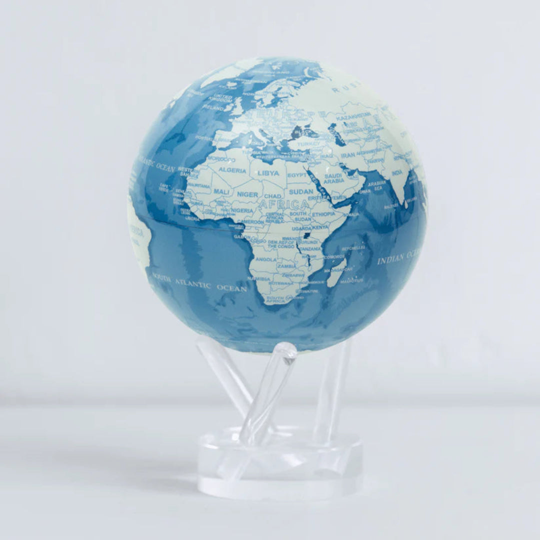 Blue and white globe on a stand against a light gray background
