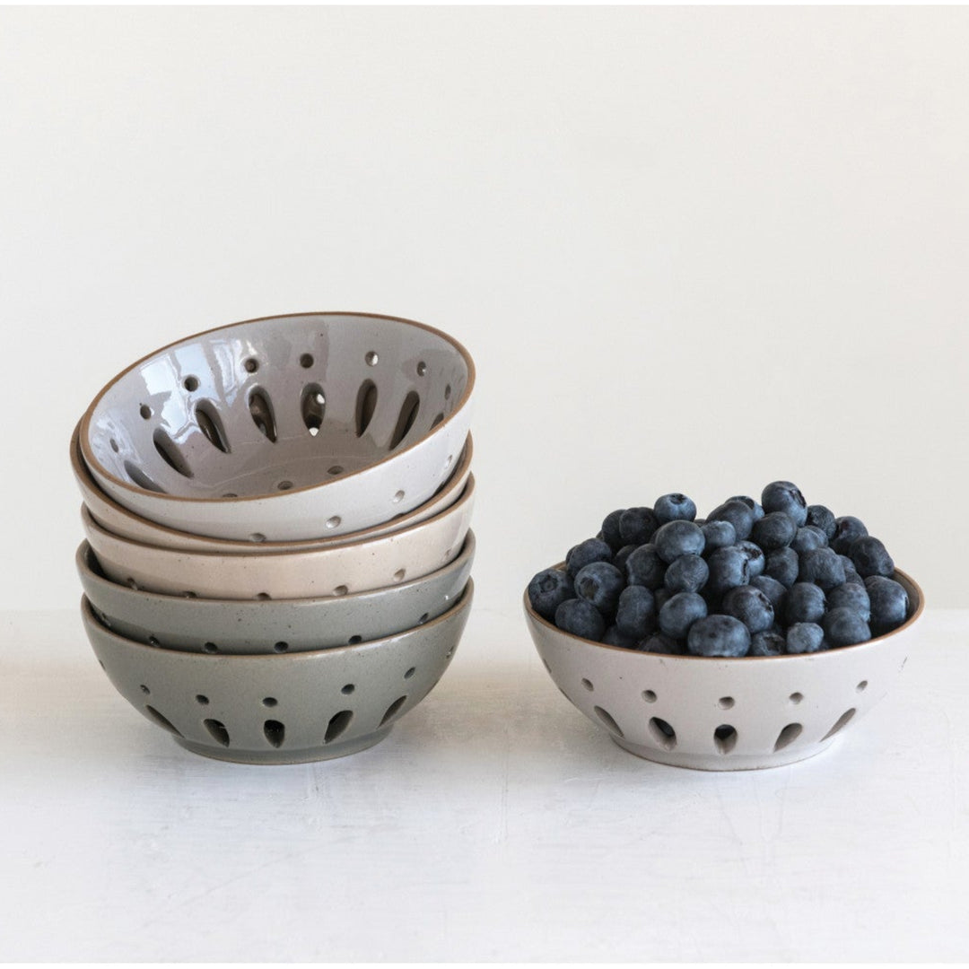 Set of ceramic bowls with blueberries on a white background