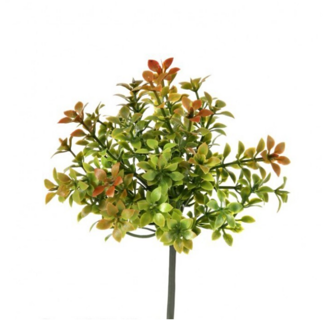 Artificial green plant with orange accents on a white background