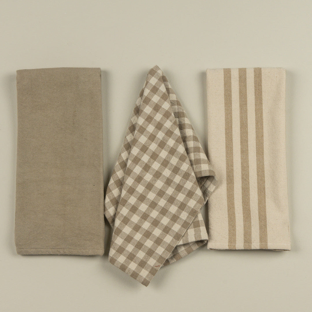 Three fabric items with different patterns on a plain background