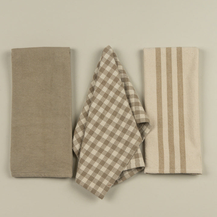 Three fabric items with different patterns on a plain background