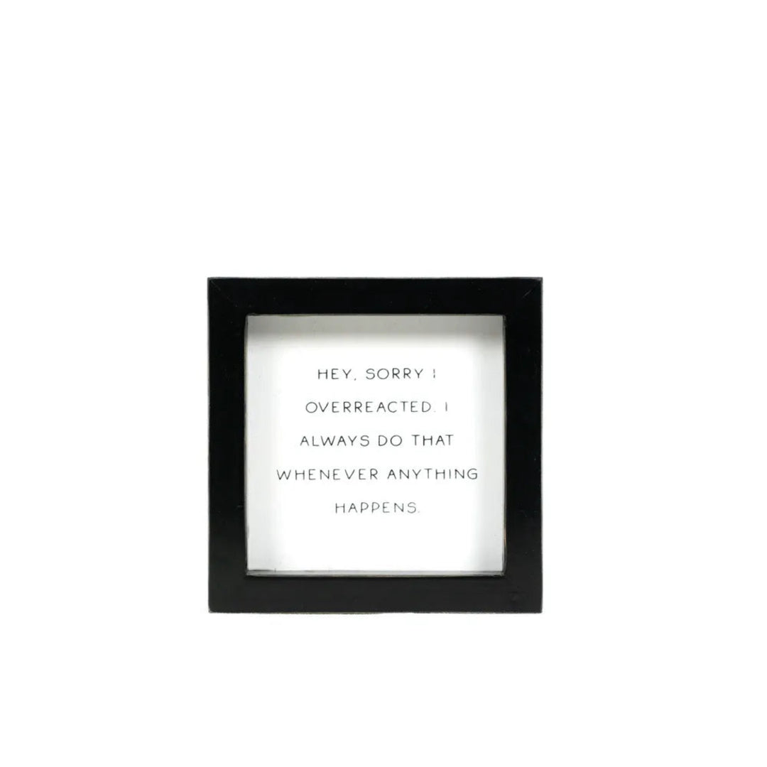 Black-framed picture with white text on a white background
