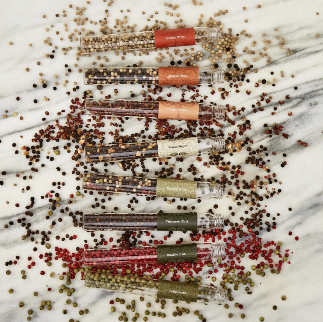 Set of small containers with spices on a marble surface