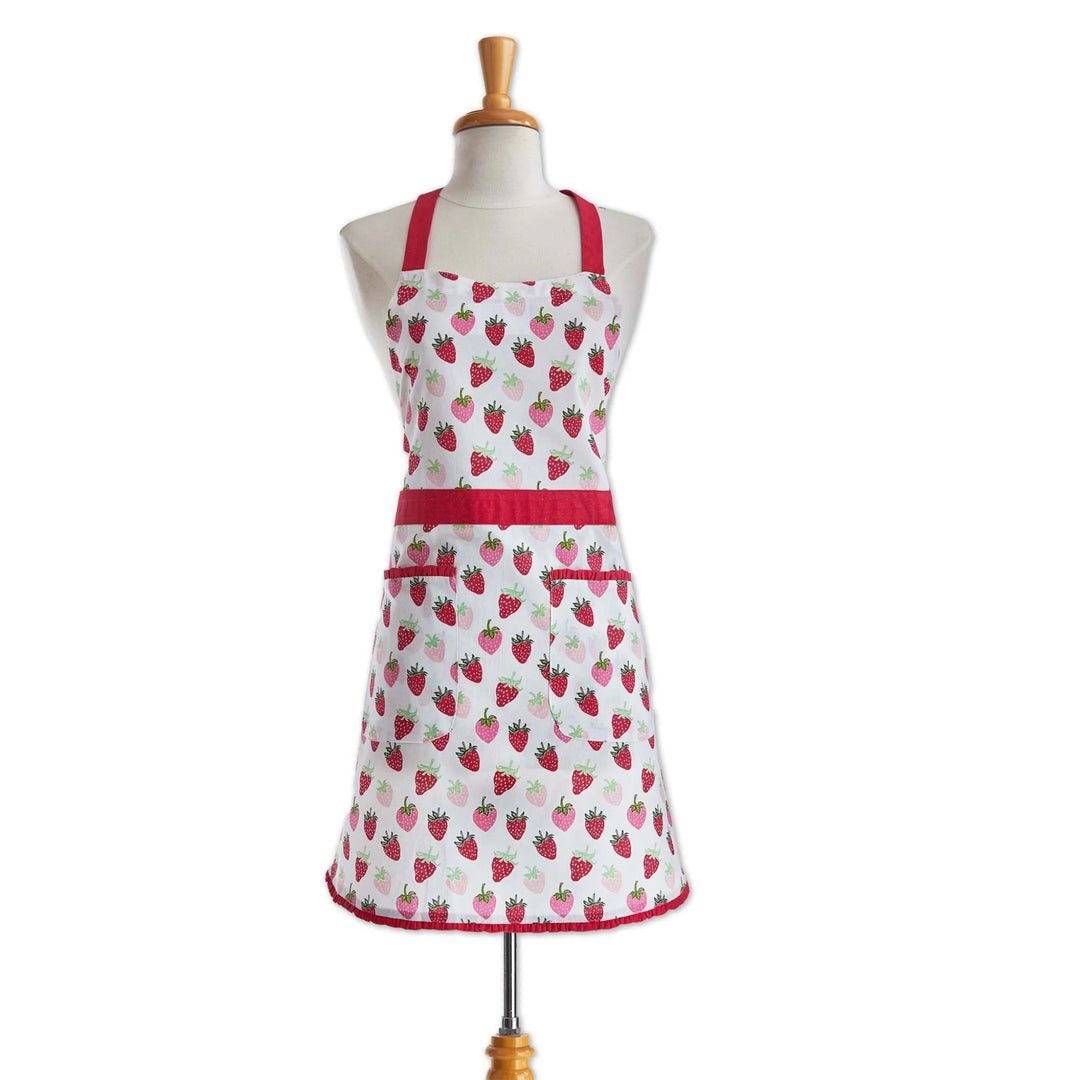 White apron with red strawberry pattern on a mannequin against a white background
