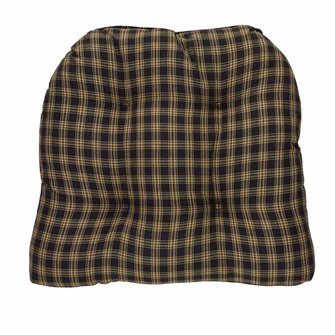 Plaid cushion with a black and gold pattern on a white background