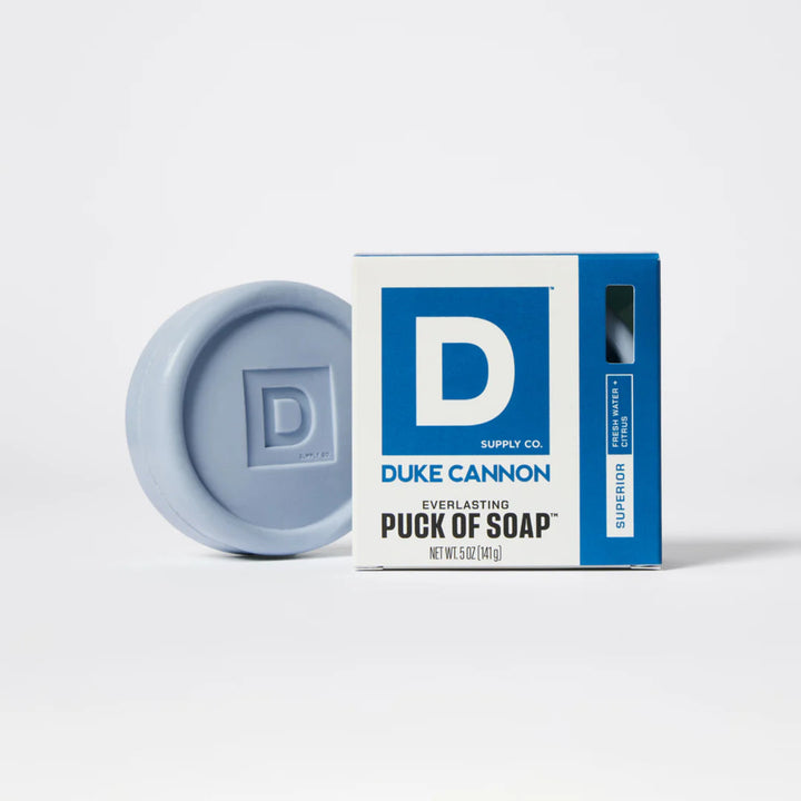 Blue soap puck with Duke Cannon packaging on a white background