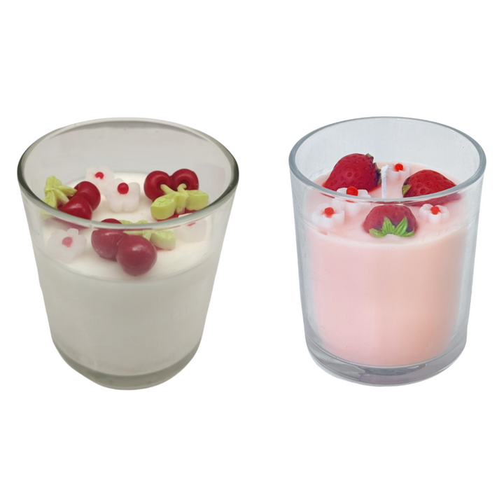 Two small glass containers with dessert and berries on a white background