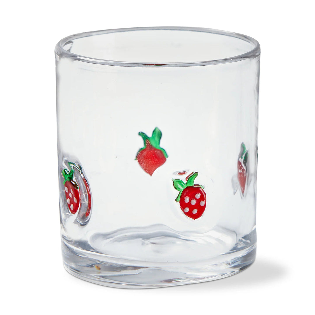 Clear glass tumbler with strawberry designs on a white background