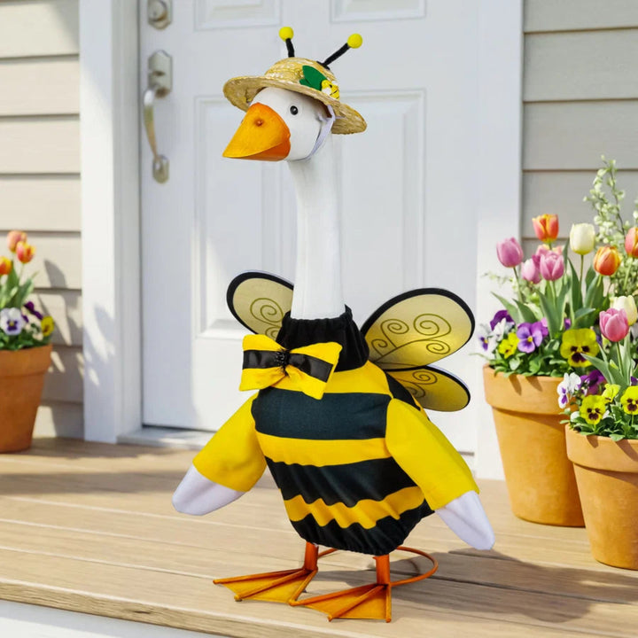 Goose wearing a bee costume on a porch with flowers
