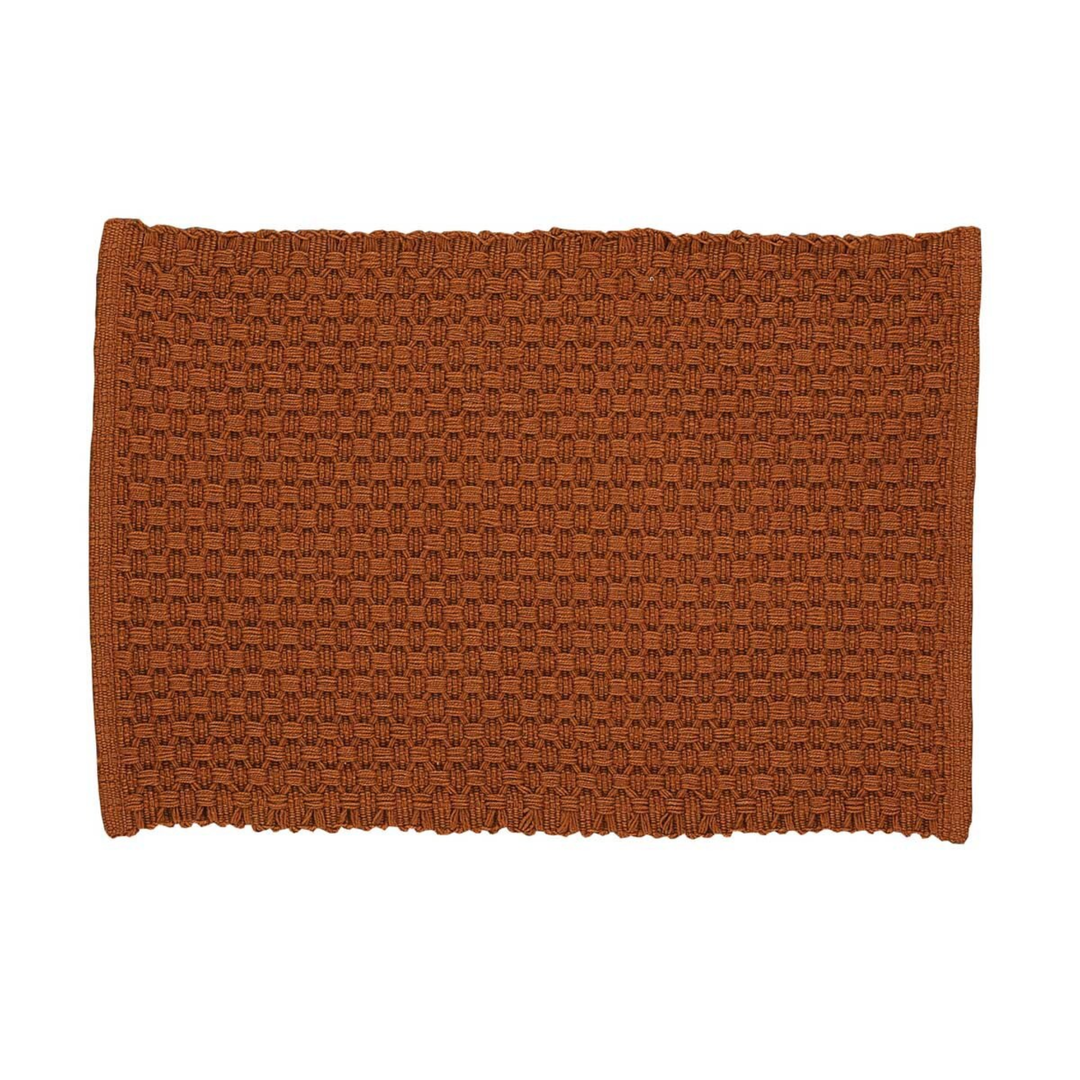 Brown woven placemat on a white background