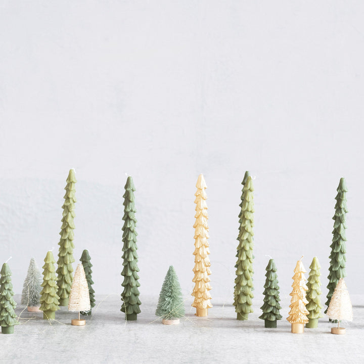 Model trees in a snowy landscape with a white background
