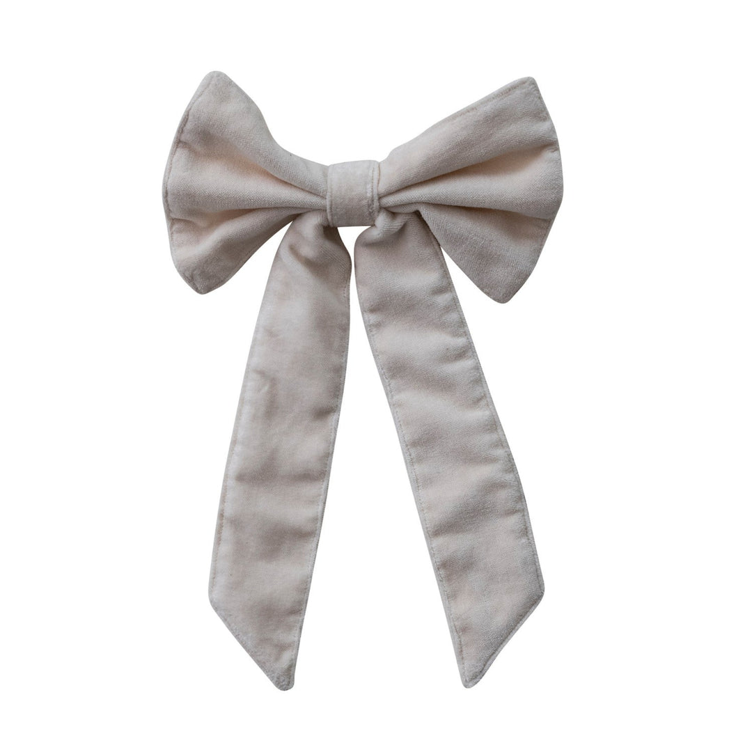 Large beige bow on a white background