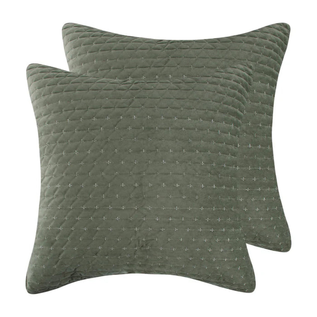 Two square quilted throw pillows in a muted sage green color, featuring a subtle stitched geometric pattern, shown against a plain white background.