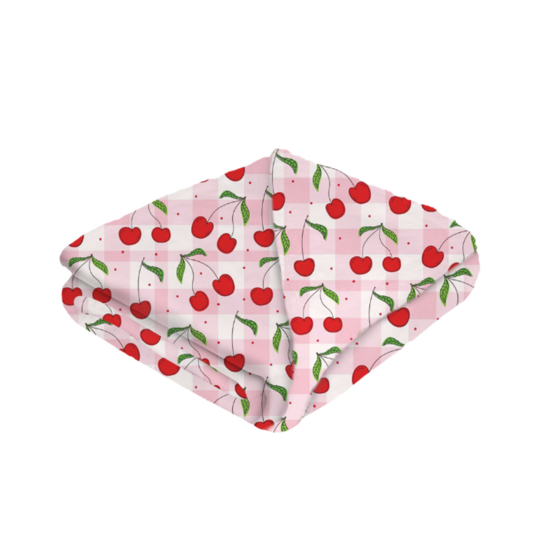 Folded fabric with cherry pattern on a white background