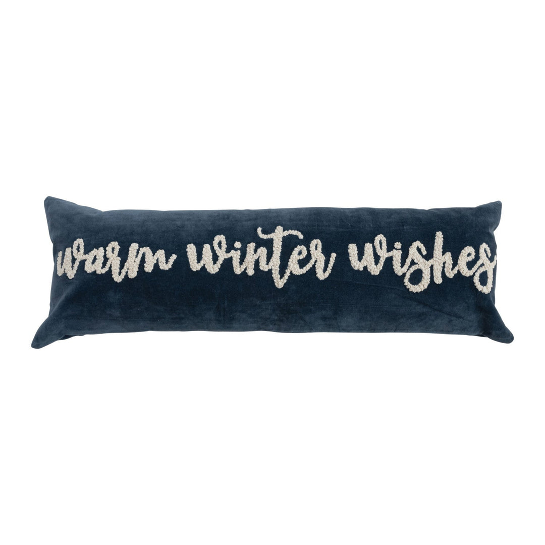 Navy blue pillow with 'warm winter wishes' text on a white background