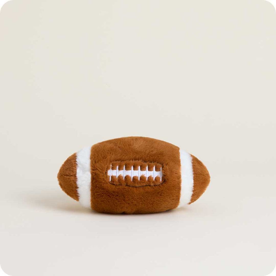 Plush football toy on a beige background