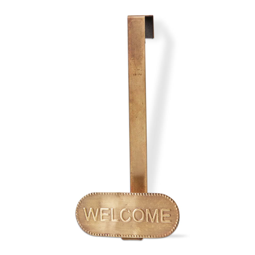 Brass door handle with 'WELCOME' engraving on a white background