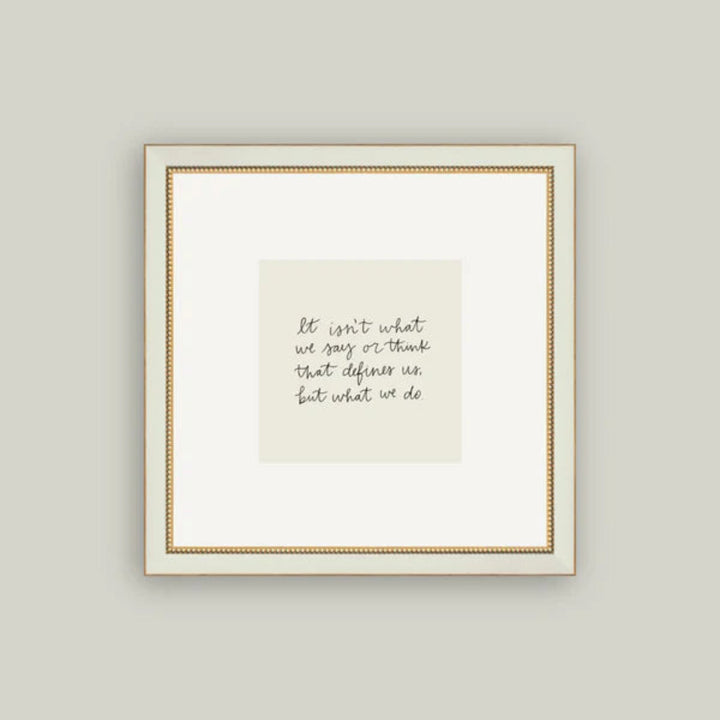 Framed print with a motivational quote on a plain wall