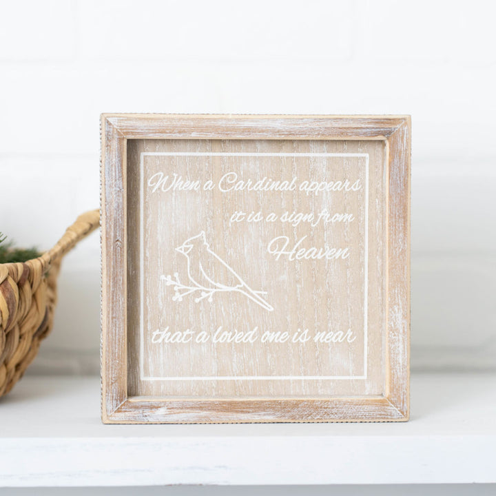 Framed print with a cardinal design and text on a white surface