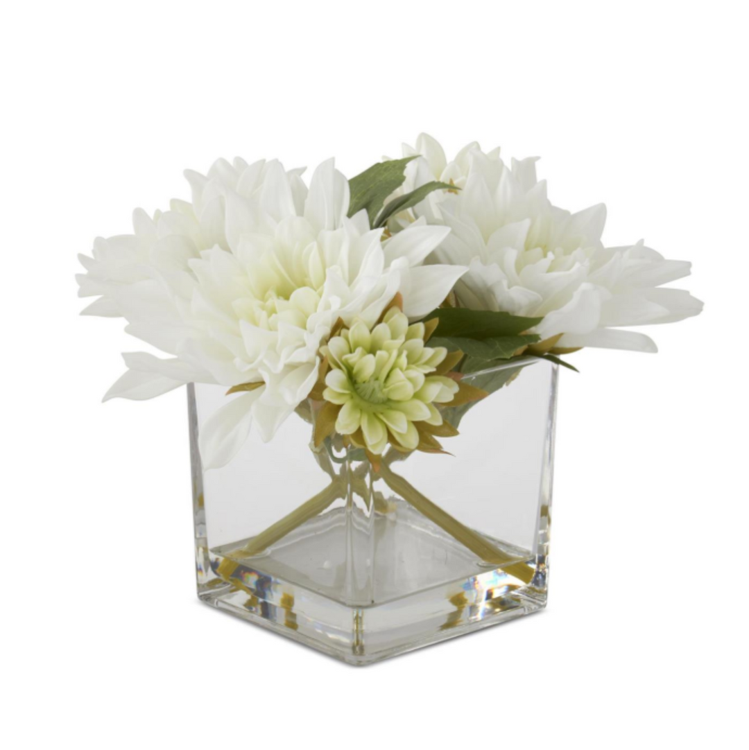 Square glass vase with white and green flowers on a white background