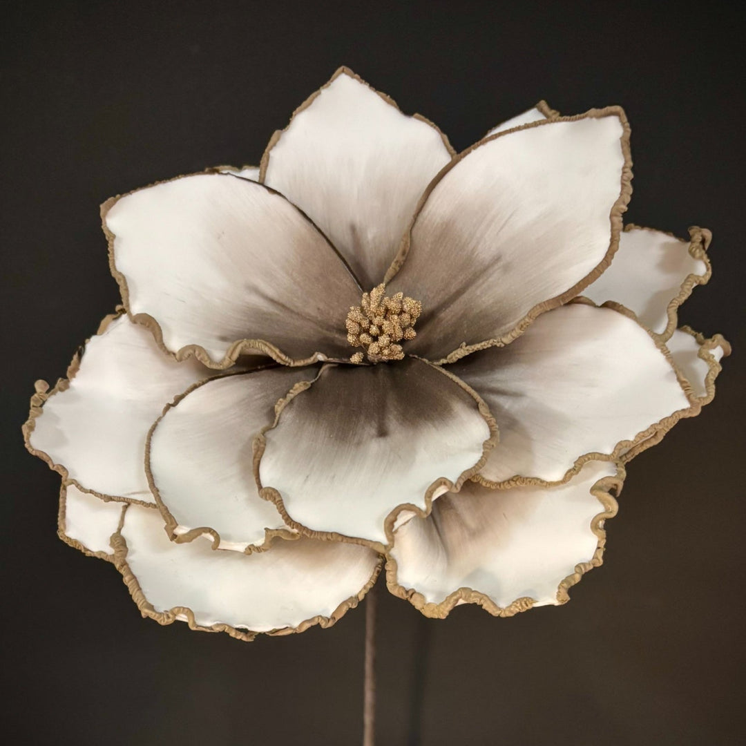 Decorative flower with gold accents on a dark background