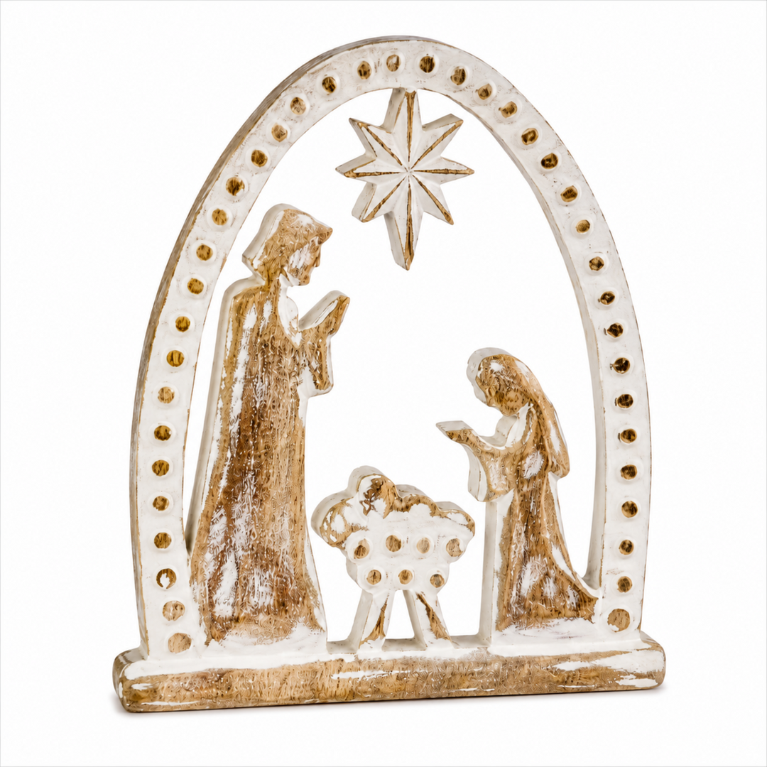 A decorative tabletop nativity scene sculpture featuring Mary, Joseph, baby Jesus, and a sheep under a star, in a distressed off-white and metallic gold finish on a white background.