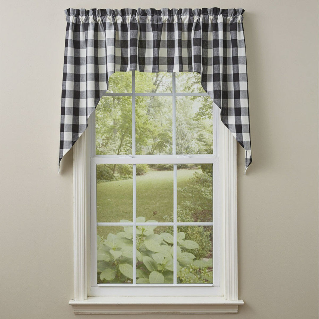 Window with checkered curtains and a view of greenery outside