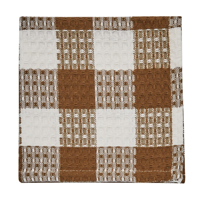 Woven fabric with brown and white checkered pattern on a white background