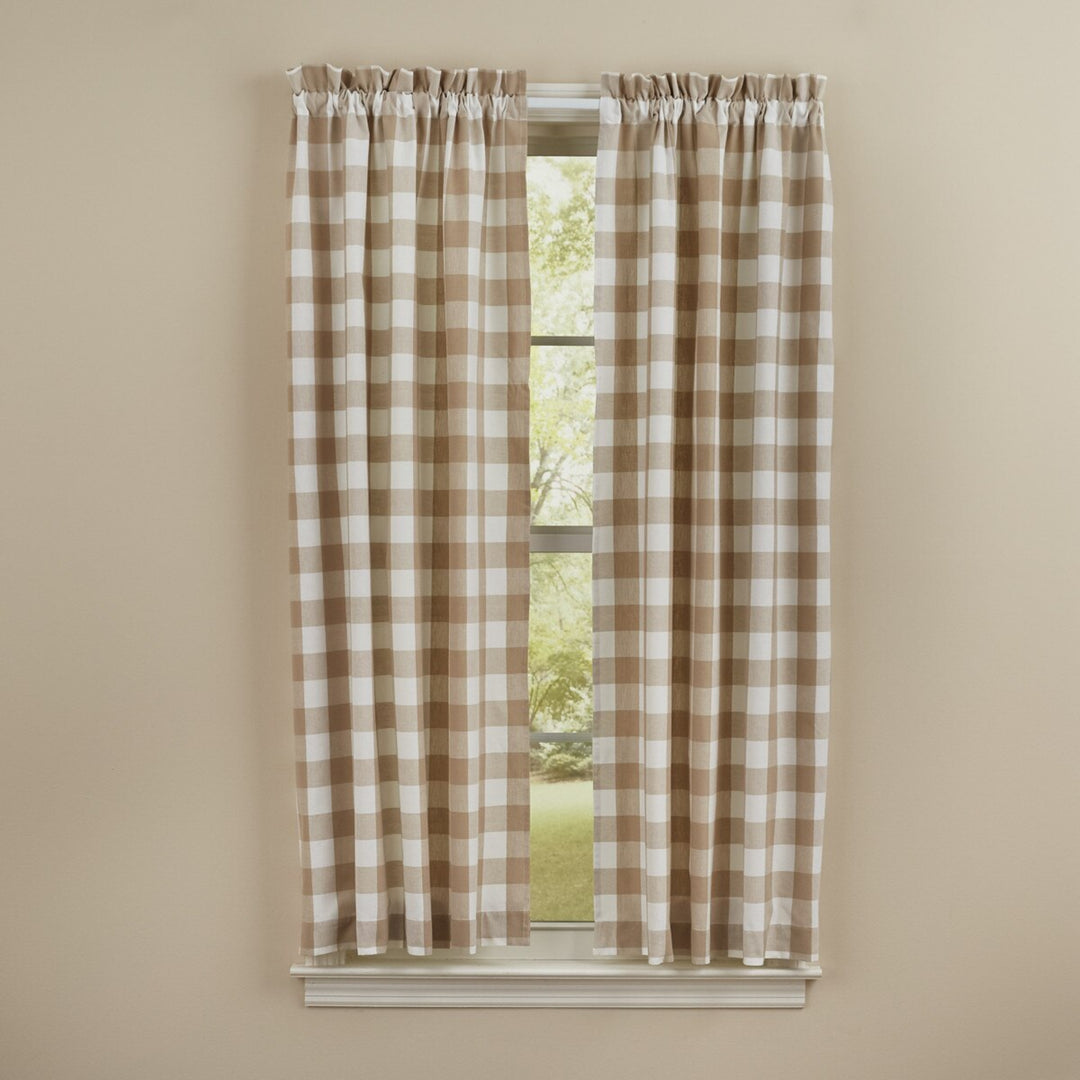 Plaid curtains on a window with a beige wall background