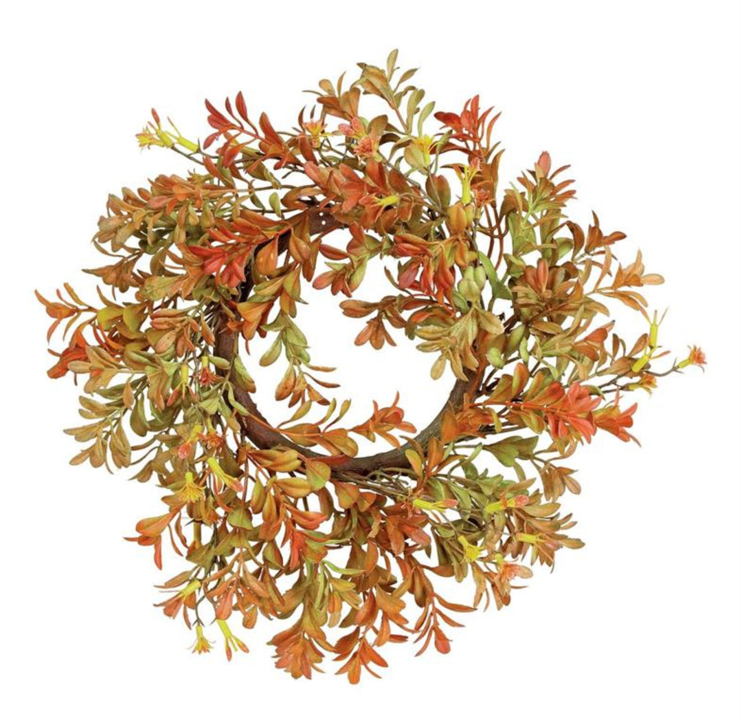 Artificial wreath with autumn leaves on a white background
