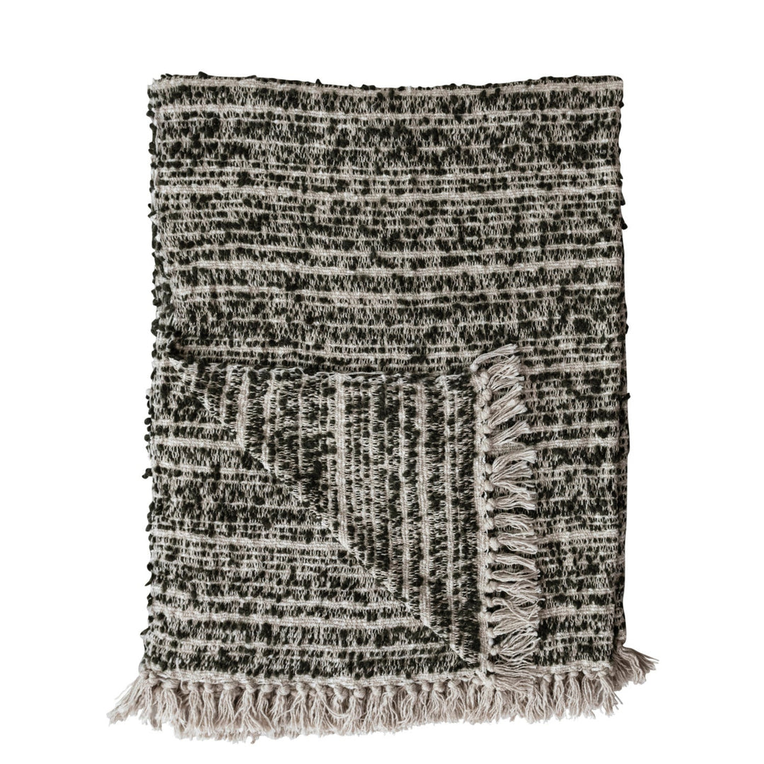 Textured throw blanket with fringes on a white background