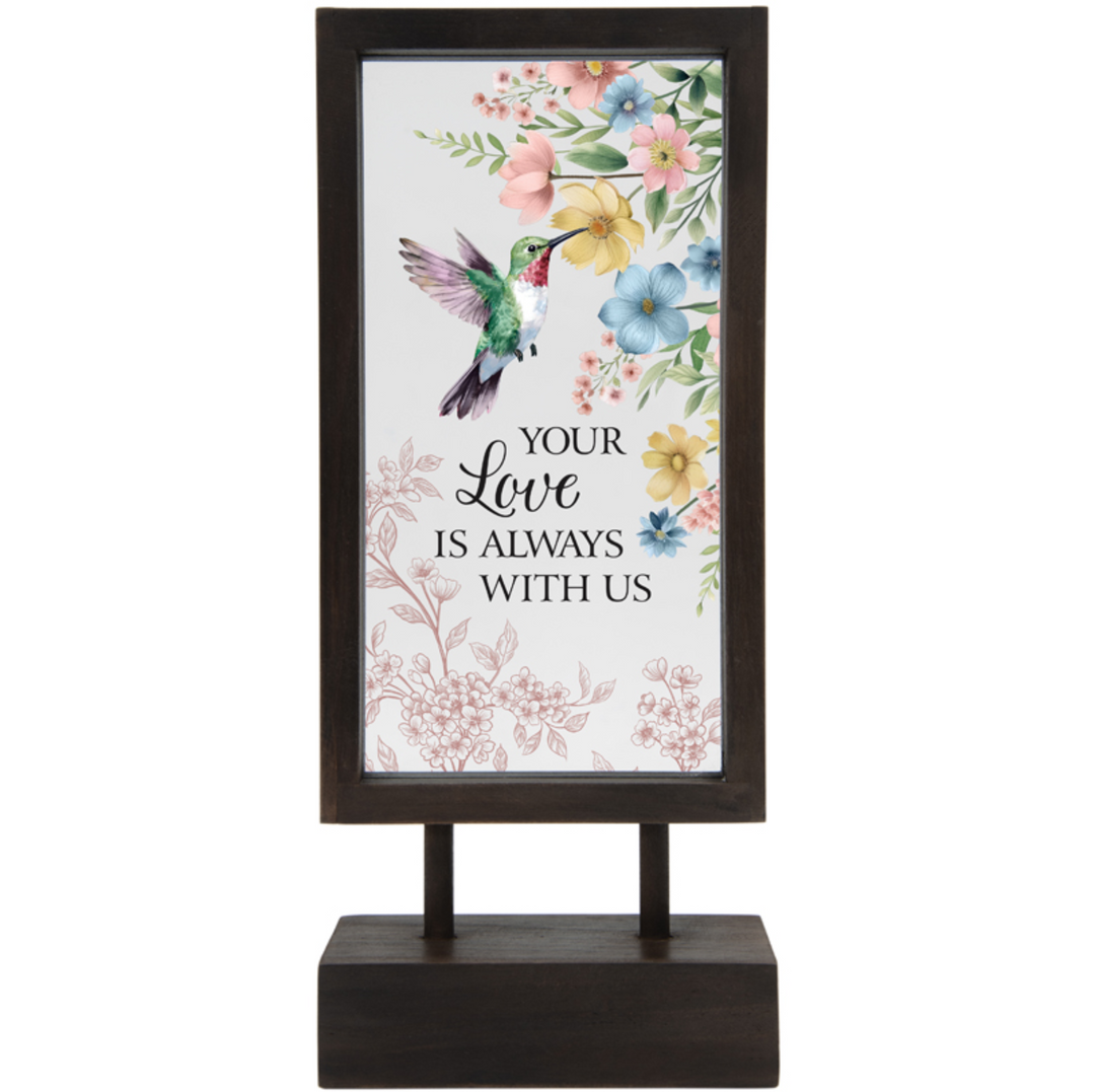 Decorative sign with floral design and text on a white background