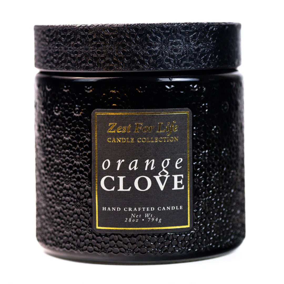 Black textured candle with 'Orange Clove' label on a white background
