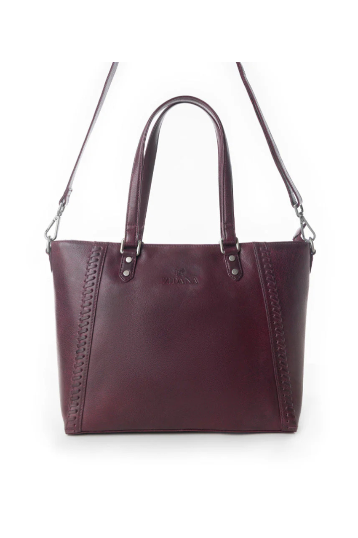 Burgundy handbag with a shoulder strap on a white background