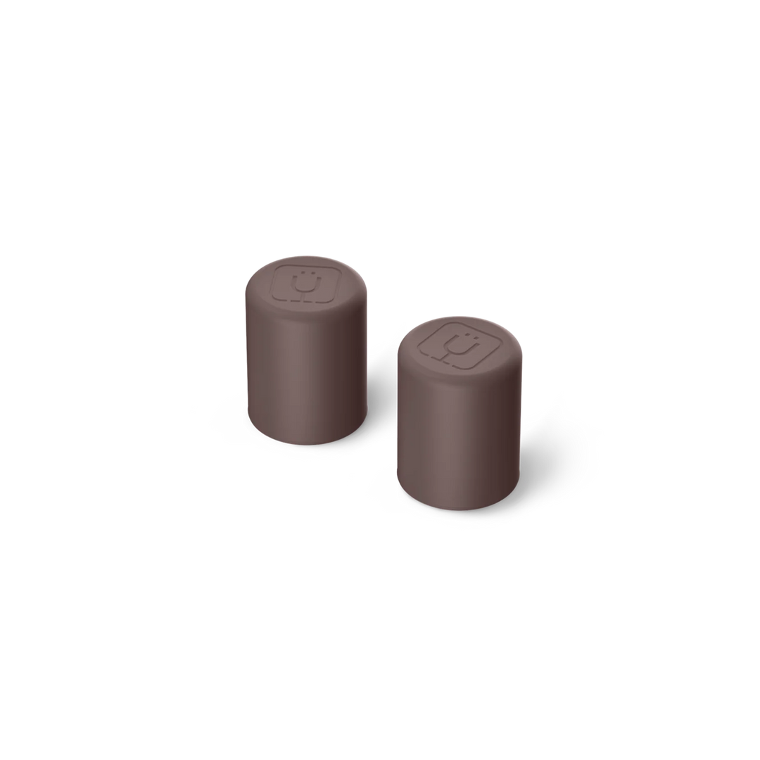 Two brown cylindrical objects on a white background