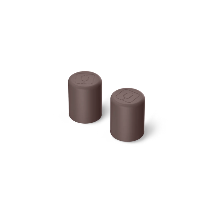 Two brown cylindrical objects on a white background