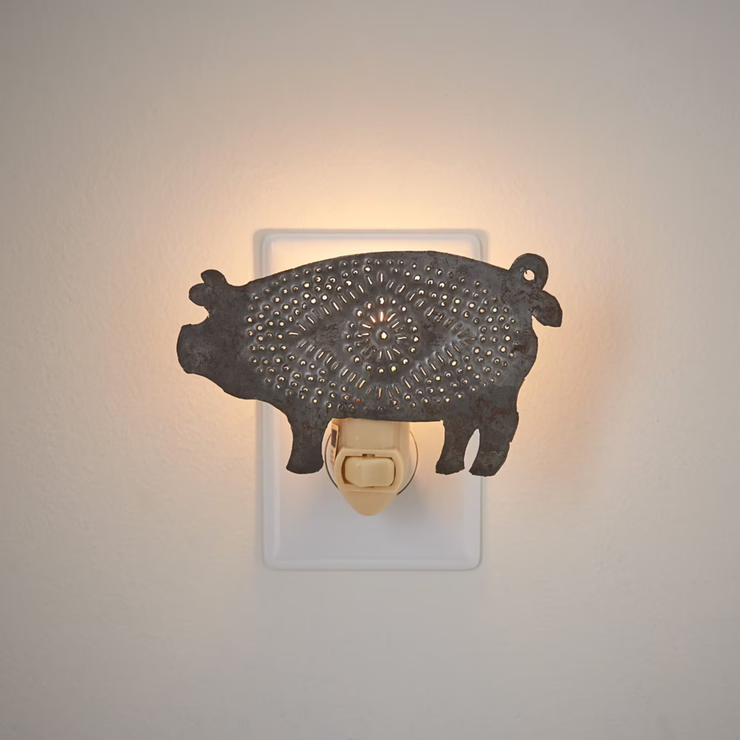 Decorative pig night light on a neutral background