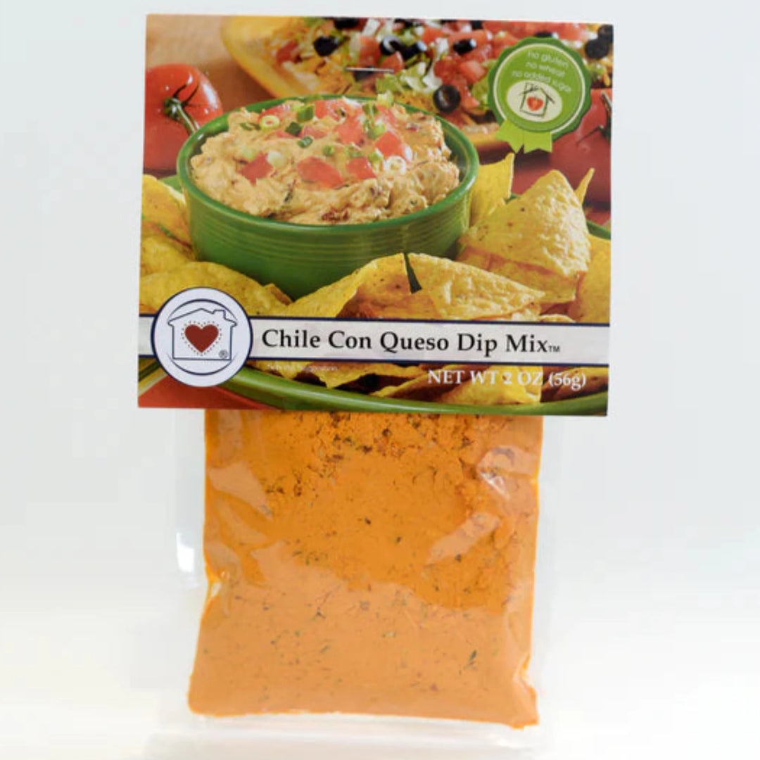 Packaging of Chile Con Queso Dip Mix with a picture of the dip served in a green bowl with tortilla chips around it.